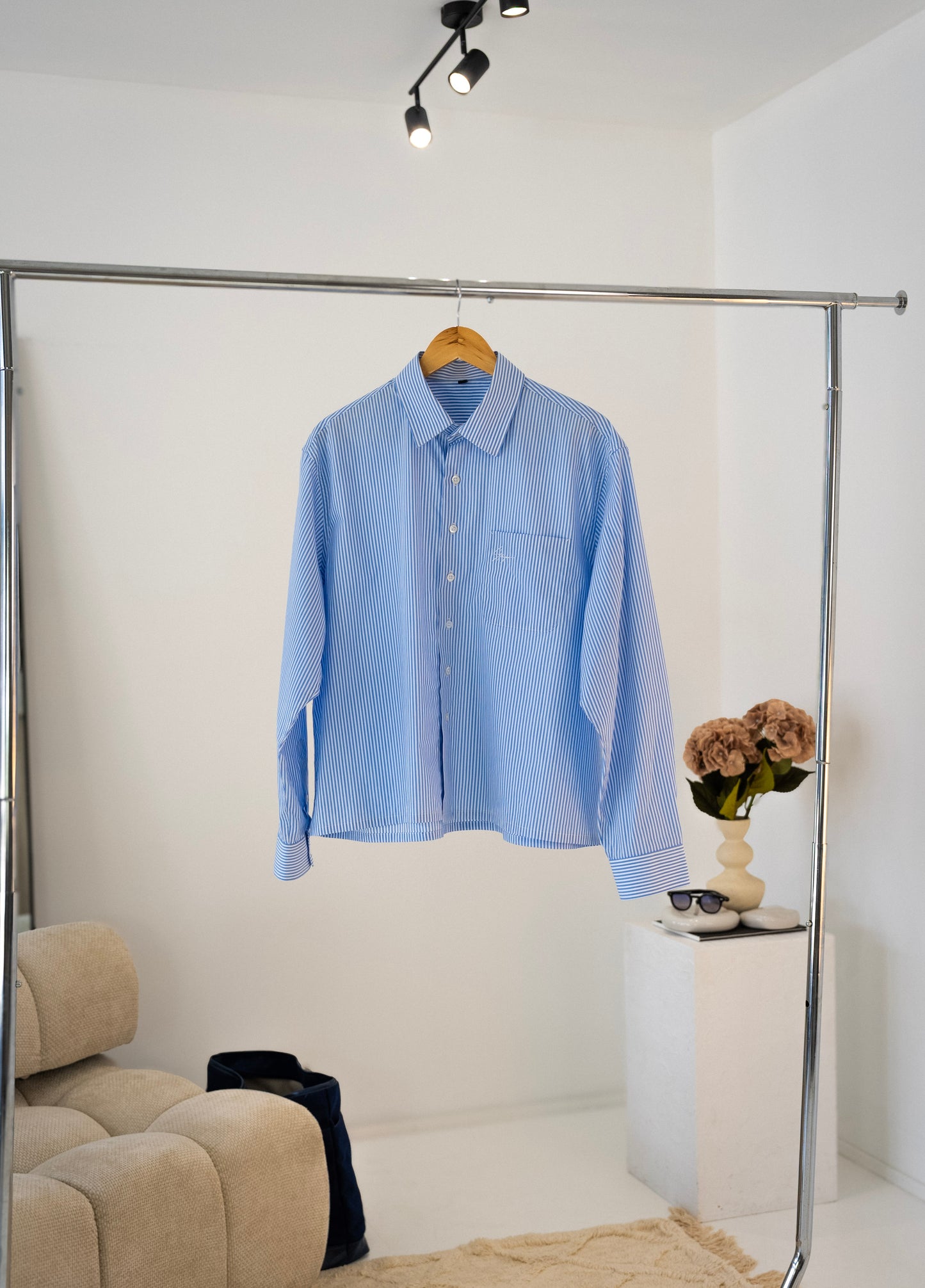 Front view of white and blue striped Stingem cotton shirt on wooden hanger.